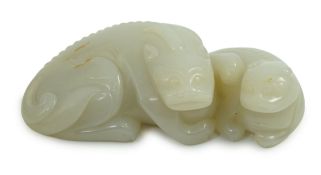 A Chinese white jade mythical beast group, the stone of good even tone with some russet patches to