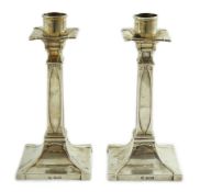 A pair of George V Arts & Crafts silver candlesticks, by William Hutton & Sons, with stylised faux