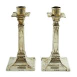 A pair of George V Arts & Crafts silver candlesticks, by William Hutton & Sons, with stylised faux