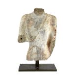 A Chinese pigment painted limestone torso of Buddha, probably Northern Qi dynasty (550-577 CE),