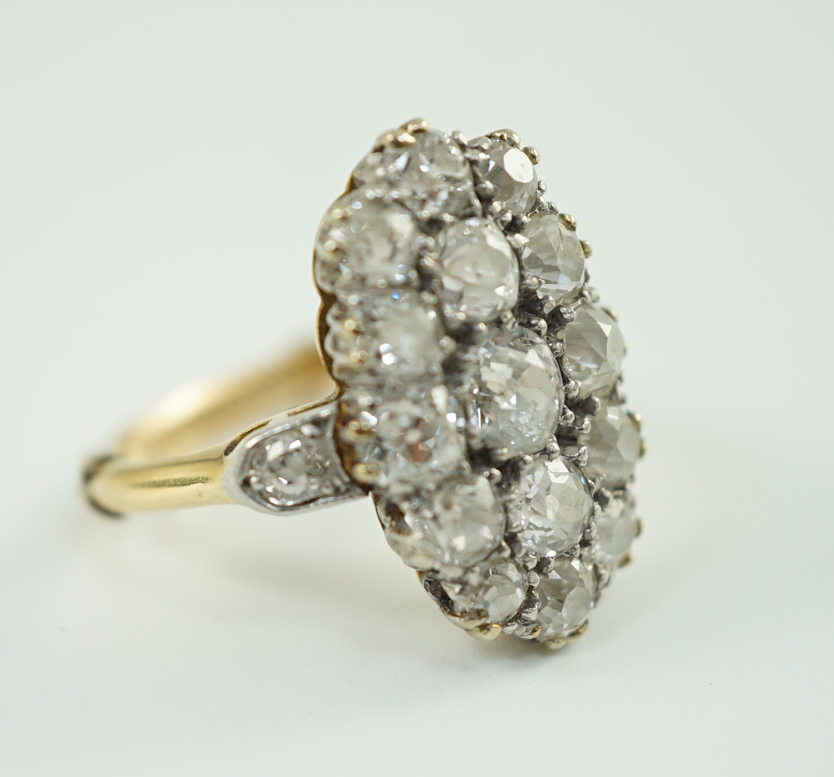 An 18ct gold and oval diamond cluster dress ring, with diamond set shoulders, set with seventeen - Image 5 of 5