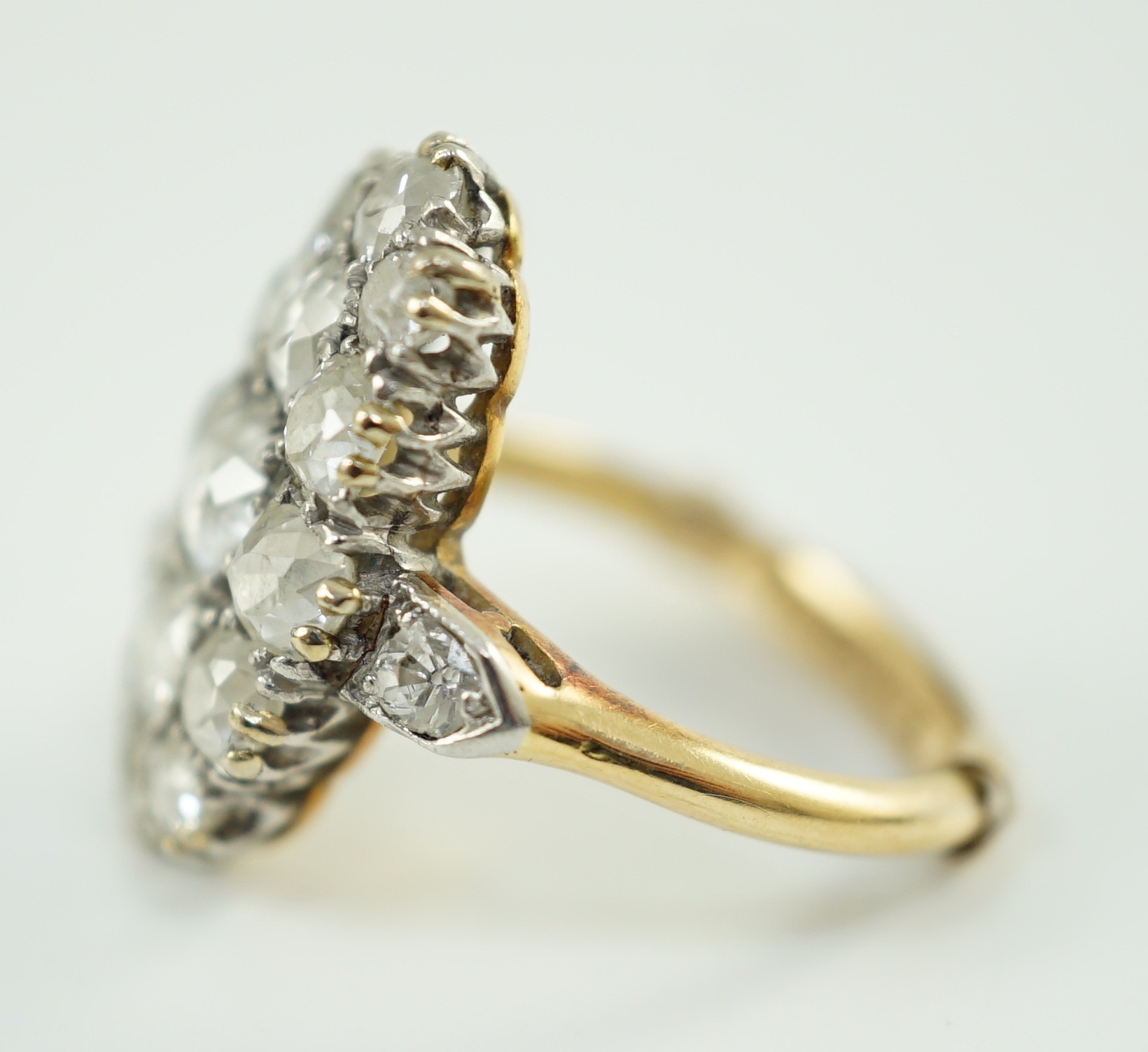 An 18ct gold and oval diamond cluster dress ring, with diamond set shoulders, set with seventeen - Image 3 of 5