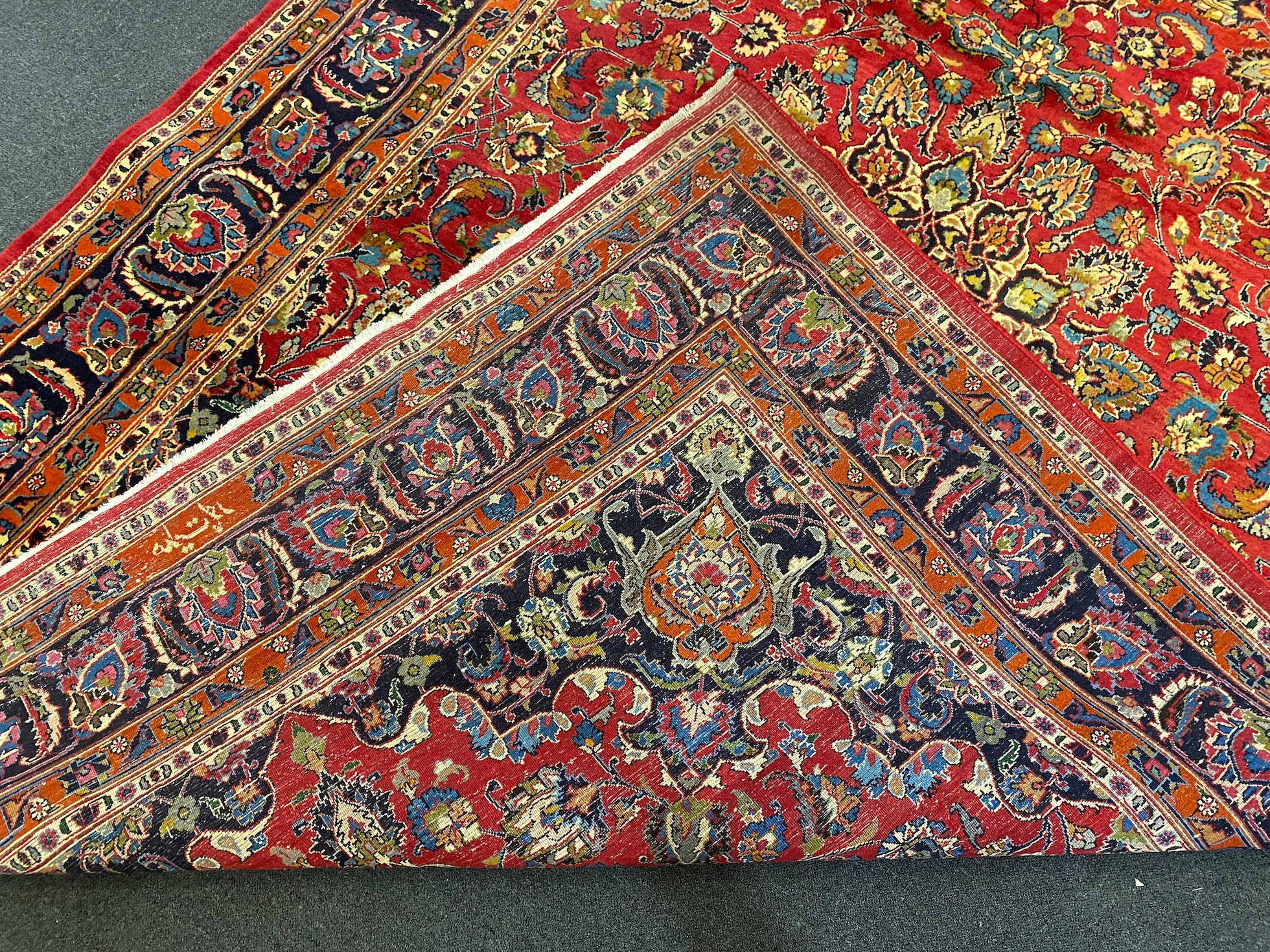 A Kashan claret ground carpet, woven with a central flowerhead medallion with palmettes and - Image 9 of 9