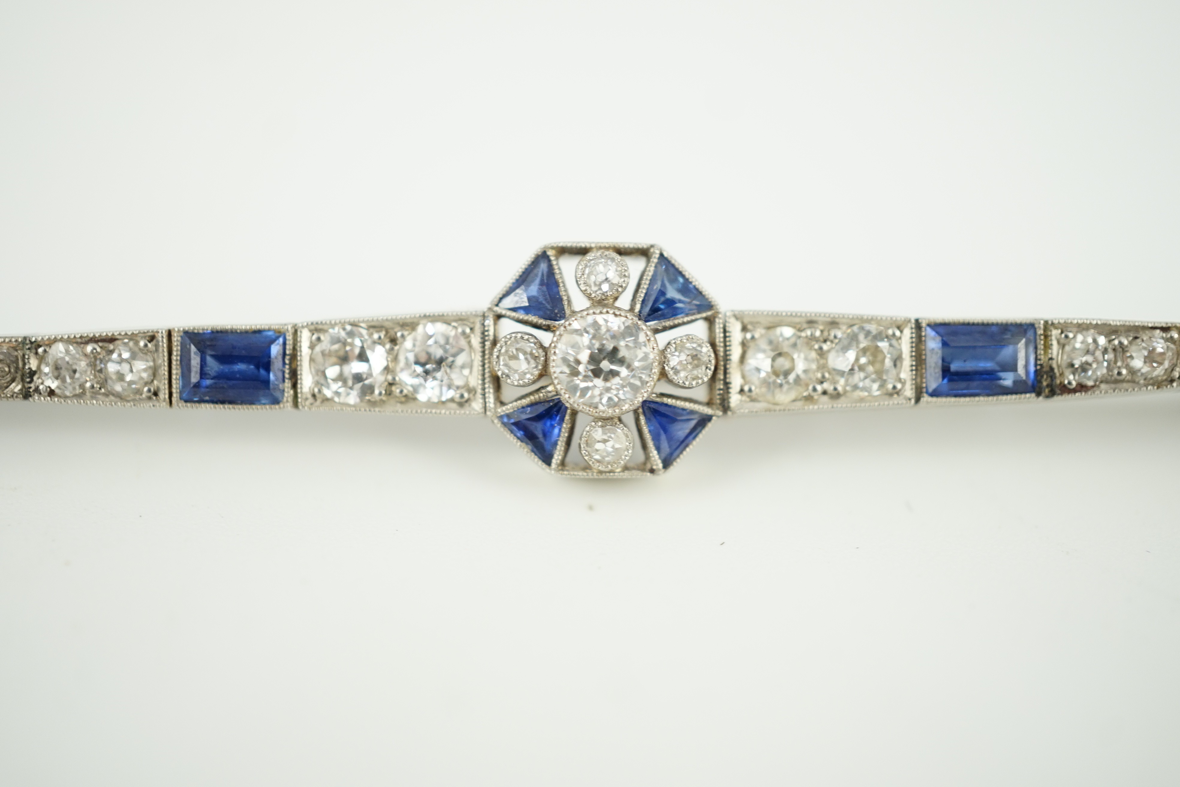 A 1920's/1930's white gold, sapphire and diamond cluster set bar brooch, with central octagonal - Image 4 of 6