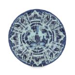 A Delft blue and white Kraak style dish, late 17th century, the centre painted with a Chinese figure