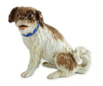 A Meissen seated figure of a German Wachtelhund (spaniel), 19th century, underglaze blue crossed