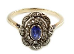 An early 20th century gold, sapphire and millegrain set rose cut diamond set oval cluster ring, size