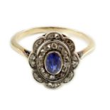 An early 20th century gold, sapphire and millegrain set rose cut diamond set oval cluster ring, size