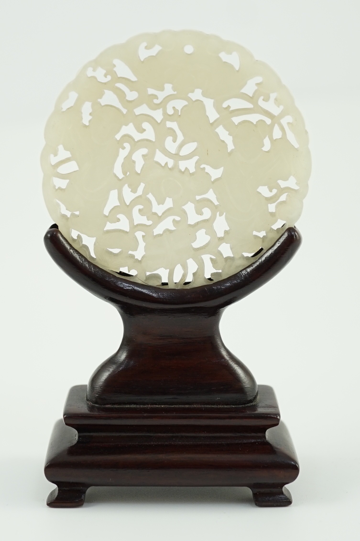 A Chinese white jade ‘Hehe Erxian’ disc, 19th/20th century, carved and pierced with a bat above - Image 3 of 5