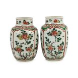 A pair of Chinese famille verte small jars, Kangxi period, each painted with flowering shrub panels,