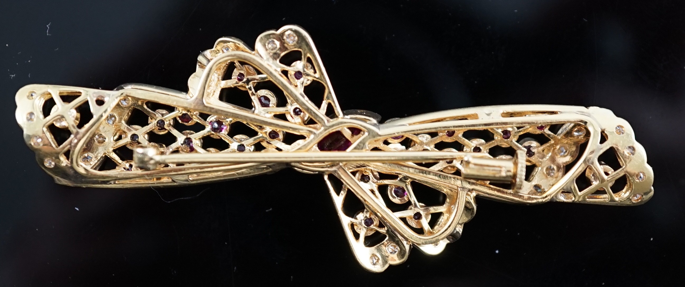 A mid to late 20th century pierced 18ct gold, ruby and diamond set ribbon bow brooch, with central - Image 2 of 2
