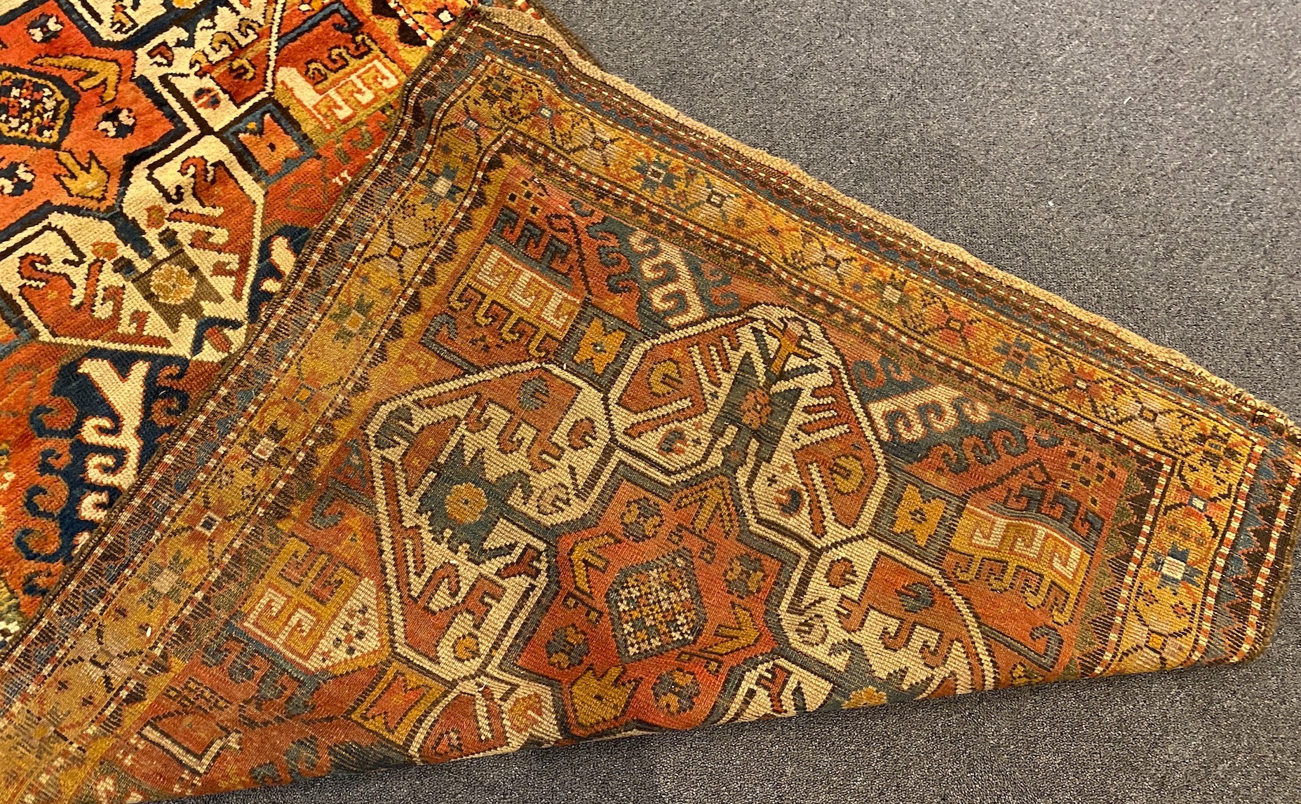 A Kazak red ground rug, with central medallions and geometric motifs, multi-bordered, 240 x - Image 5 of 5