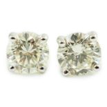 A pair of 18ct white gold and solitaire diamond set ear studs, the total diamond weight