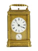 A late 19th century French engraved gilt brass gorge-cased repeating carriage clock with alarm, with