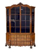A late 18th century Dutch marquetry inlaid walnut serpentine display cabinet, with arched cornice