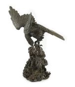 A Japanese bronze model an eagle standing on a rock, Meiji period, in two parts, incised five