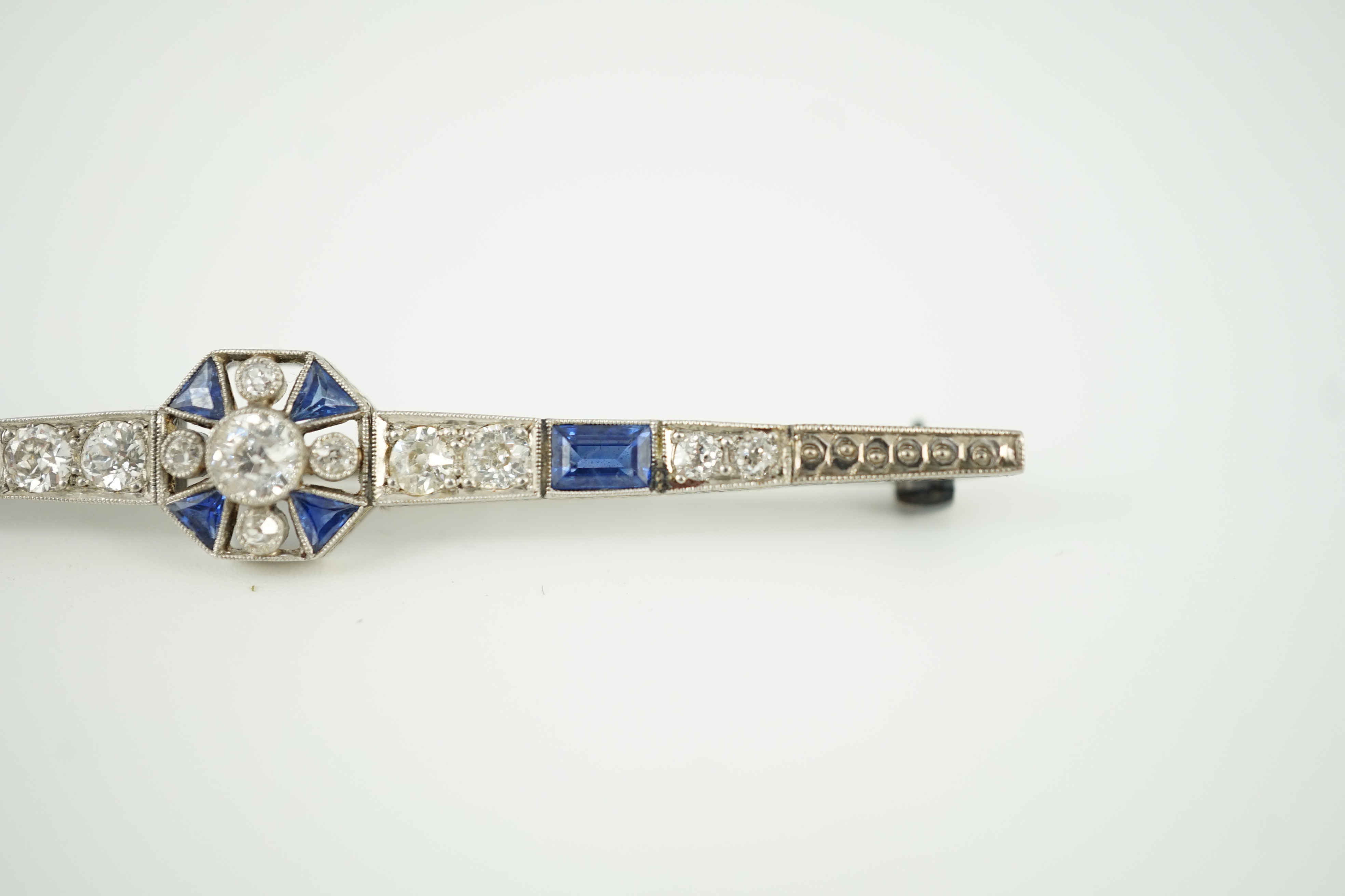 A 1920's/1930's white gold, sapphire and diamond cluster set bar brooch, with central octagonal - Image 5 of 6