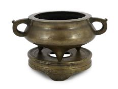 A Chinese bronze censer and stand, ding, 18th/19th century, the squat baluster shaped censer with