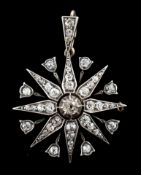A late Victorian gold, silver and diamond cluster set starburst pendant, with central recess for