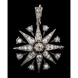 A late Victorian gold, silver and diamond cluster set starburst pendant, with central recess for