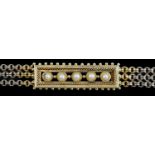 An early 20th century triple strand gold bracelet with central rectangular motif set with five