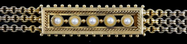 An early 20th century triple strand gold bracelet with central rectangular motif set with five