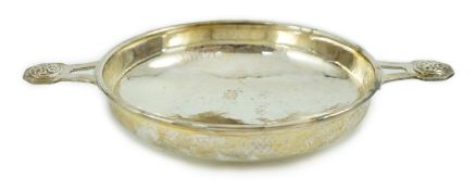 A George V Arts & Crafts planished silver two handled shallow dish, by Albert Edward Jones, the