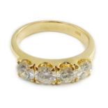 A modern 750 gold and four stone diamond set ring, each stone weighing approximately 0.30ct, size L,