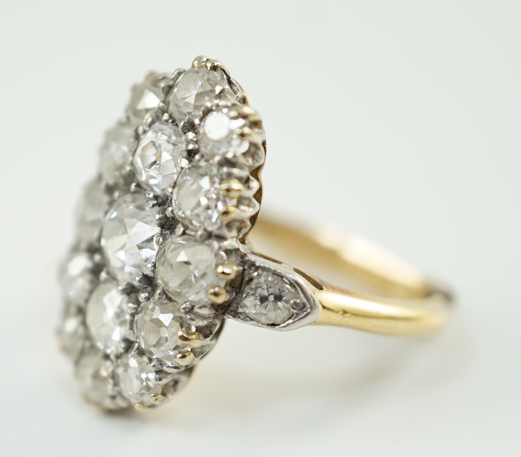 An 18ct gold and oval diamond cluster dress ring, with diamond set shoulders, set with seventeen - Image 2 of 5