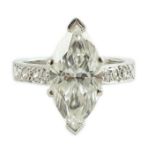 A modern 18ct white gold and single stone marquise diamond set dress ring, with graduated diamond
