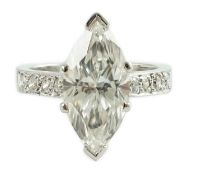 A modern 18ct white gold and single stone marquise diamond set dress ring, with graduated diamond