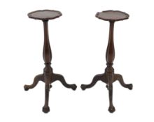 A pair of 18th century Dutch mahogany and oak torchere stands, with piecrust tops and fluted