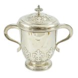 A George VI silver two handled cup and cover by William Comyns & Sons Ltd, with card cut decoration,