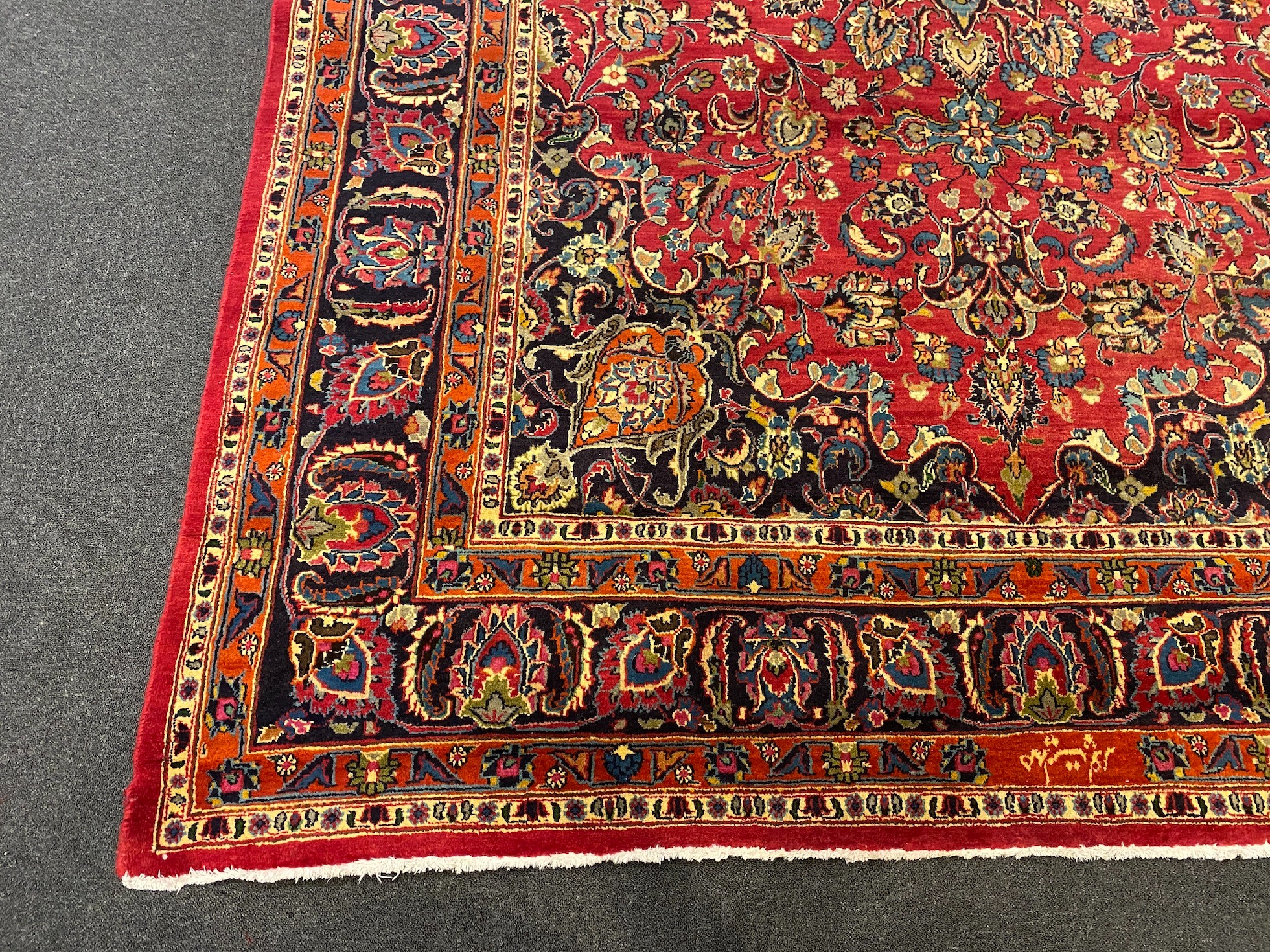 A Kashan claret ground carpet, woven with a central flowerhead medallion with palmettes and - Image 2 of 9