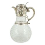 A Victorian embossed silver mounted engraved glass claret jug, the glass later, the silver,