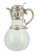 A Victorian embossed silver mounted engraved glass claret jug, the glass later, the silver,