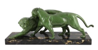 Plagner. An Art Deco patinated spelter group of two panthers, standing upon a veined marble base