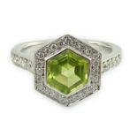 A modern 18ct white gold, peridot and diamond set hexagonal cluster set dress ring, with diamond set