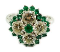 An 18ct white gold, emerald and diamond cluster set dress ring, the four diamonds with a total