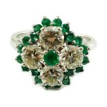 An 18ct white gold, emerald and diamond cluster set dress ring, the four diamonds with a total