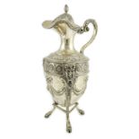 An 18th century French silver vase shaped claret jug, decorated with paterae and swags, on tripod