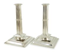 A large pair of George V silver cluster column candlesticks, by William Comyns & Sons Ltd, on