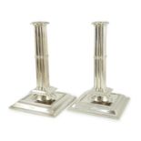 A large pair of George V silver cluster column candlesticks, by William Comyns & Sons Ltd, on