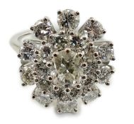 A platinum? and twenty one round cut diamond set oval cluster dress ring, the central stone weighing