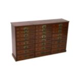 A Victorian mahogany haberdashery cabinet of twenty four drawers, with moulded top and recessed