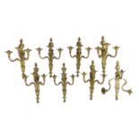 A set of eight cast gilt brass three branch wall sconces Height 23cm Width 22cm***CONDITION