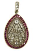 A 1920's pierced gold and platinum, millegrain set ruby and diamond oval pendant, set with round and