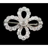 A 1940's white gold? and millegrain set diamond cluster set open work quatrefoil shaped brooch,