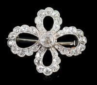 A 1940's white gold? and millegrain set diamond cluster set open work quatrefoil shaped brooch,