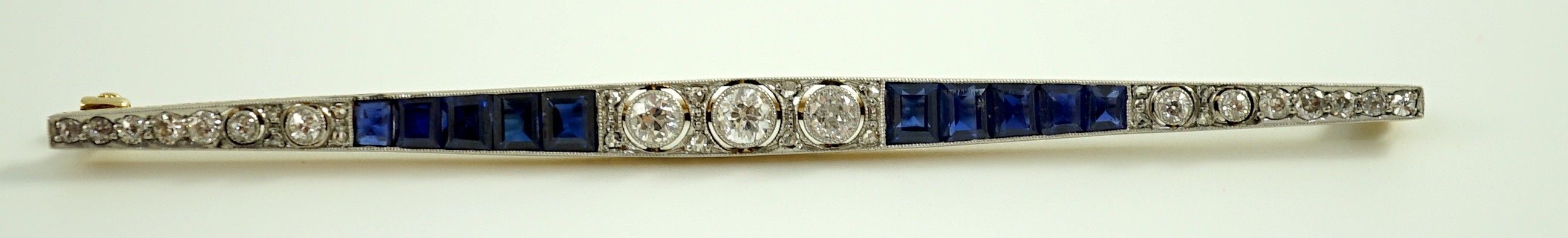 A 1920's/1930's 15ct gold and platinum, diamond and synthetic? sapphire set bar brooch, of - Image 2 of 3